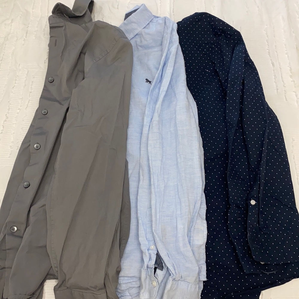 3 button down boys shirts together.